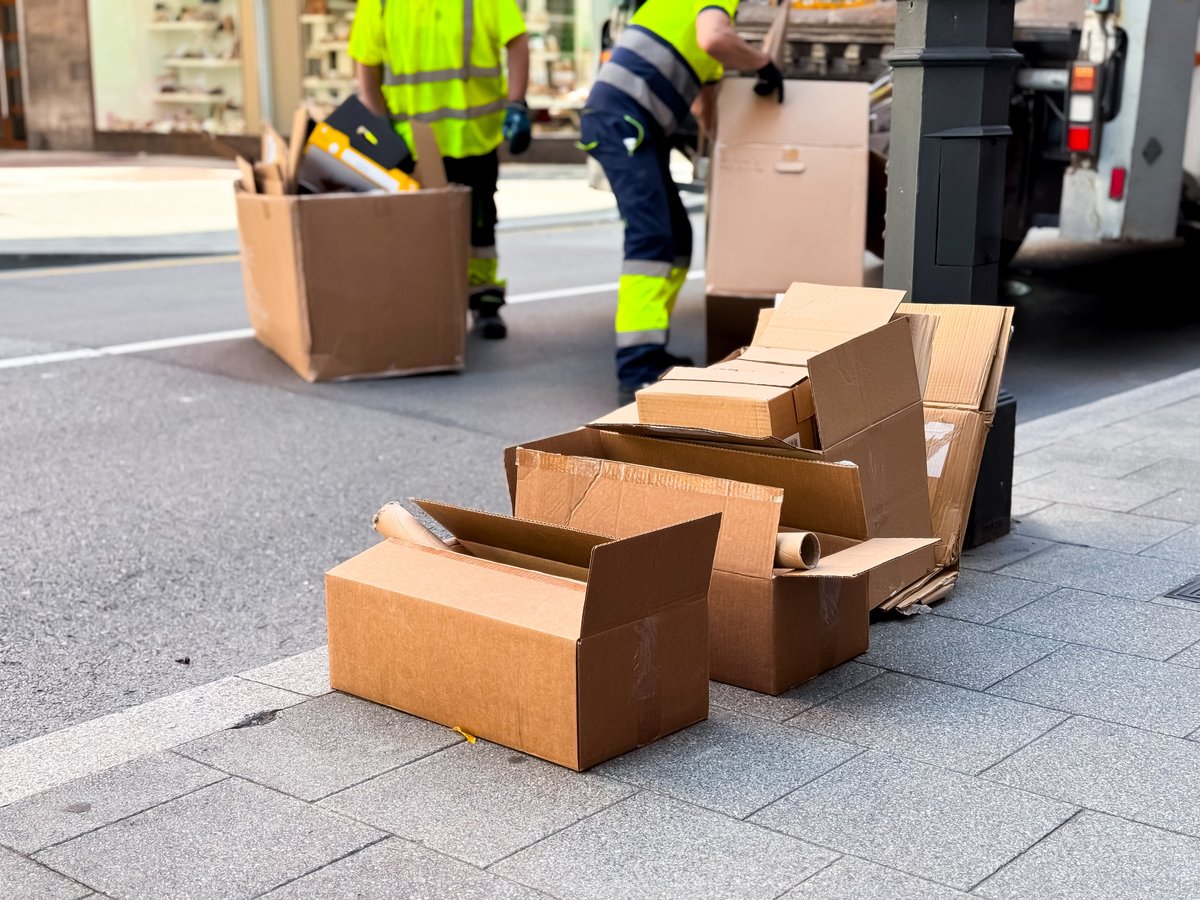 Workers loading debris and junk onto a truck