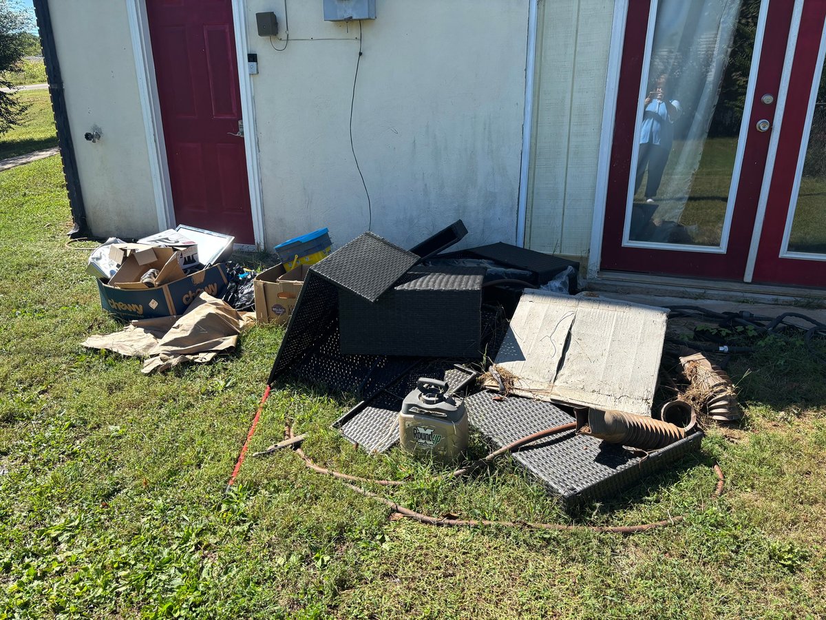 Pile of discarded materials and debris outside a house awaiting removal by Brock Property Services